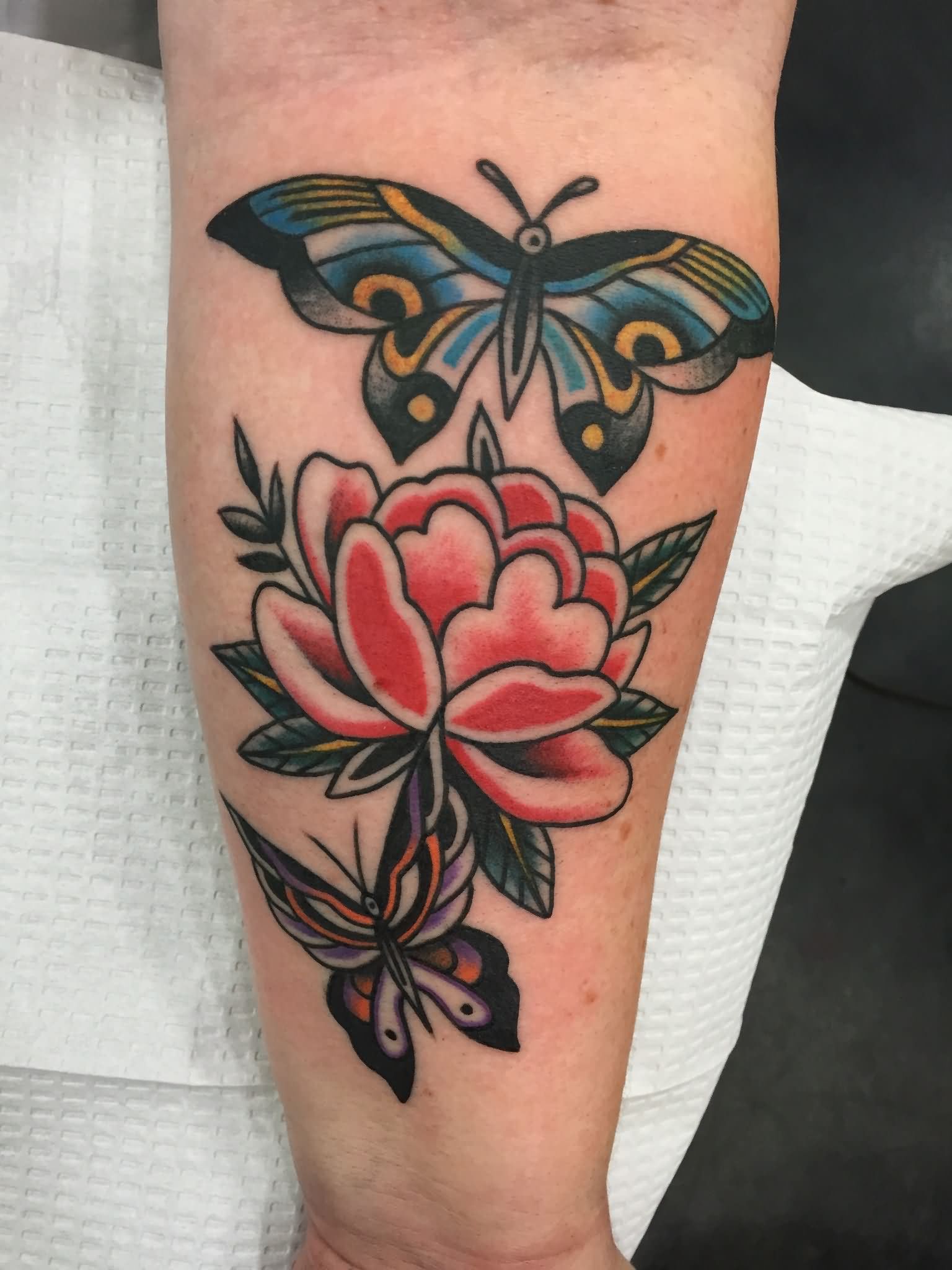 Traditional Flower With Two Flying Butterflies Tattoo On Forearm By Kohen Meyers
