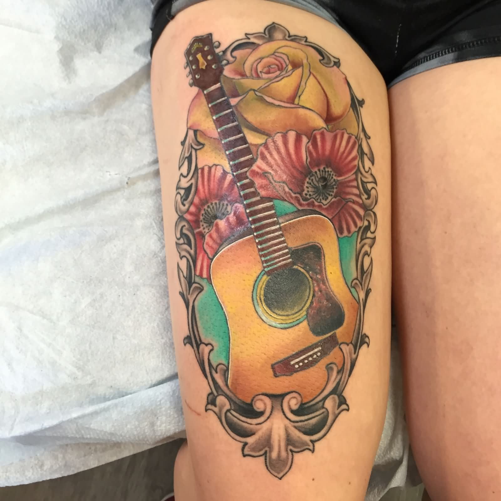 Traditional Guitar With Flowers In Frame Tattoo On Right Thigh By Daniel Troyer