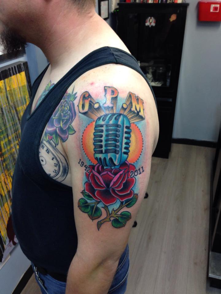 Traditional Mic With Rose Tattoo On Man Left Half Sleeve By Pig Legion