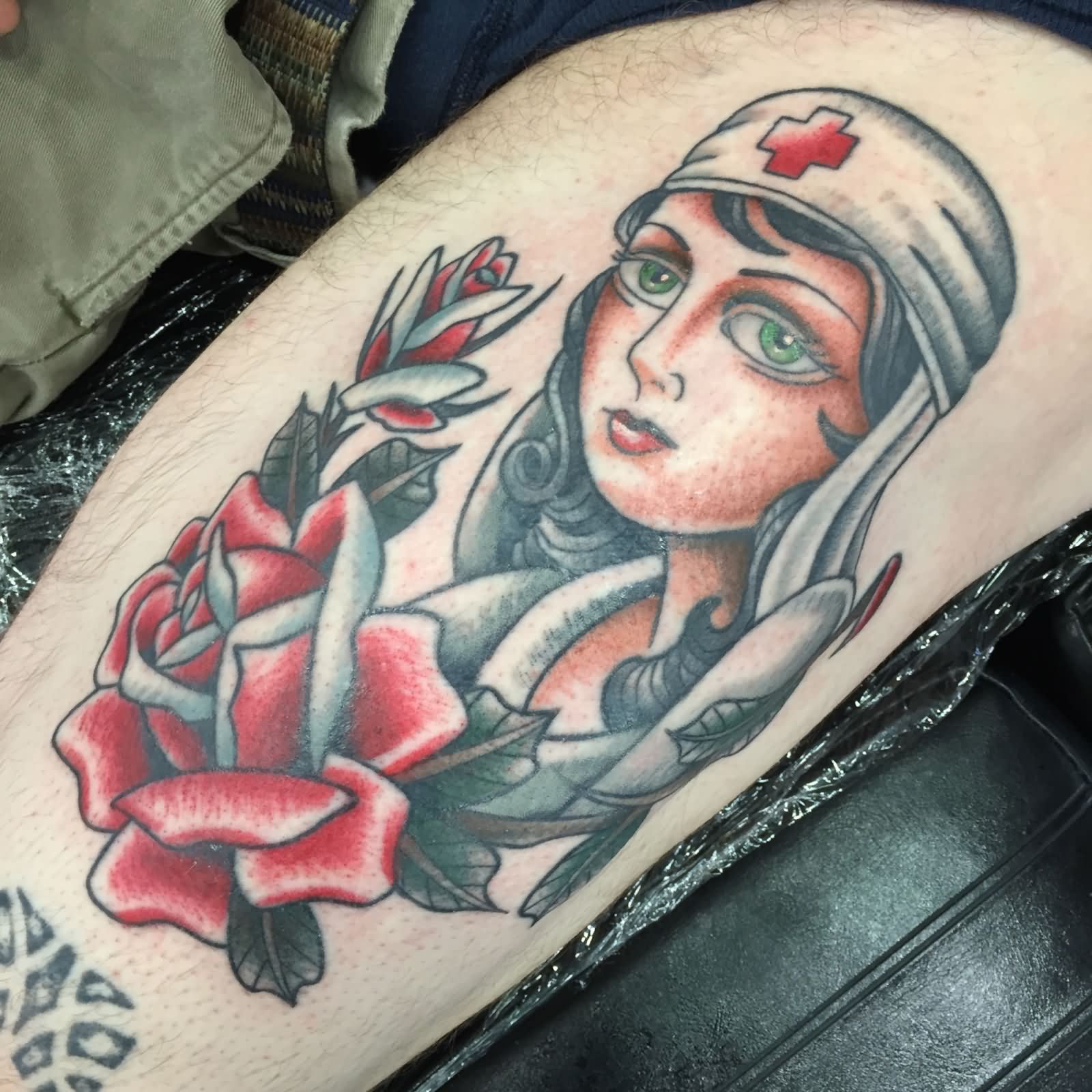 Traditional Nurse Face With Rose Tattoo On Left Thigh By Kohen Meyers