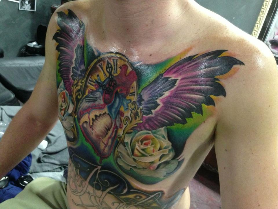 Traditional Real Heart With Wings And Clock Tattoo On Man Chest By Fabz