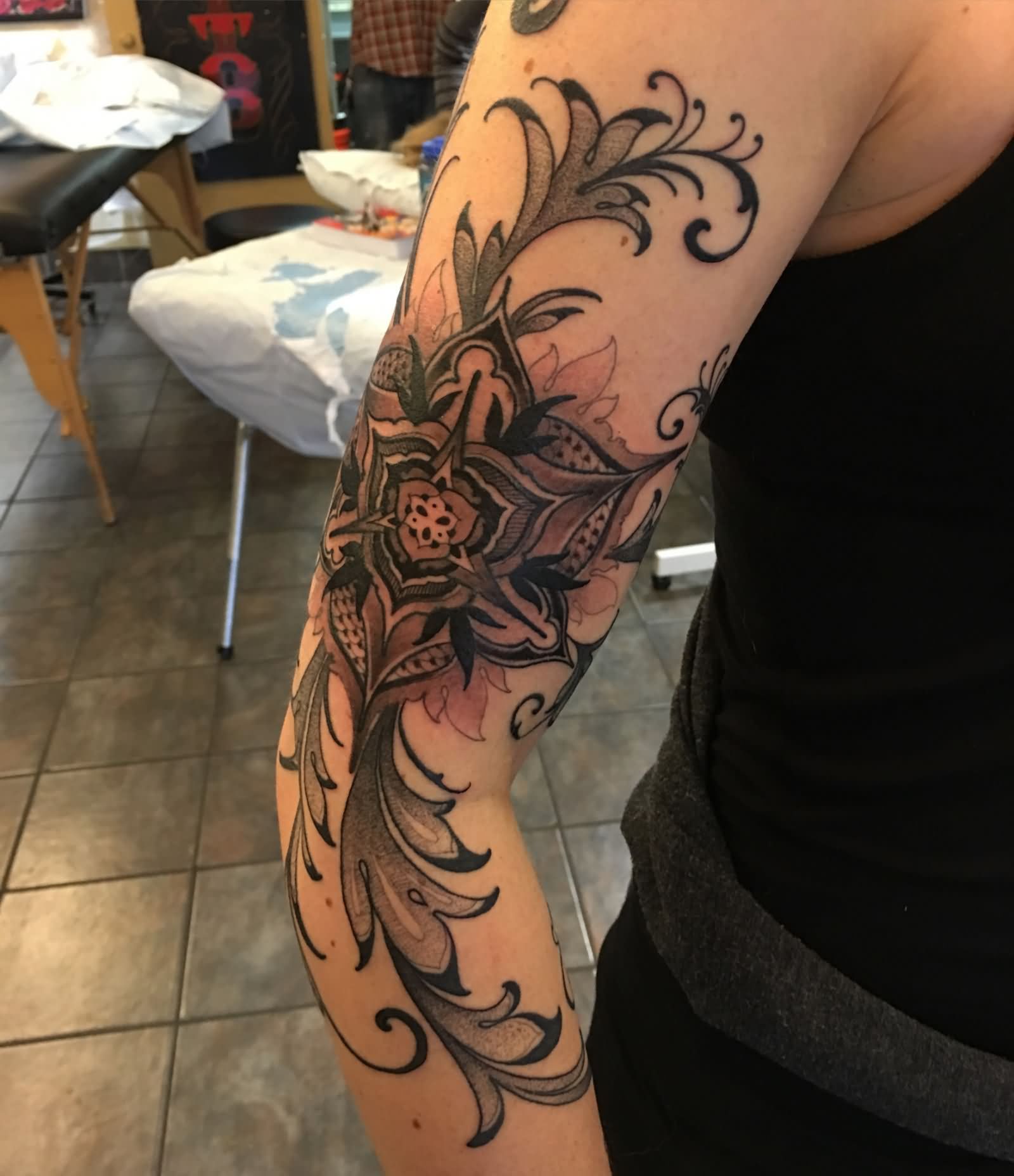 Wonderful Black Ink Flower Tattoo On Man Right Half Sleeve