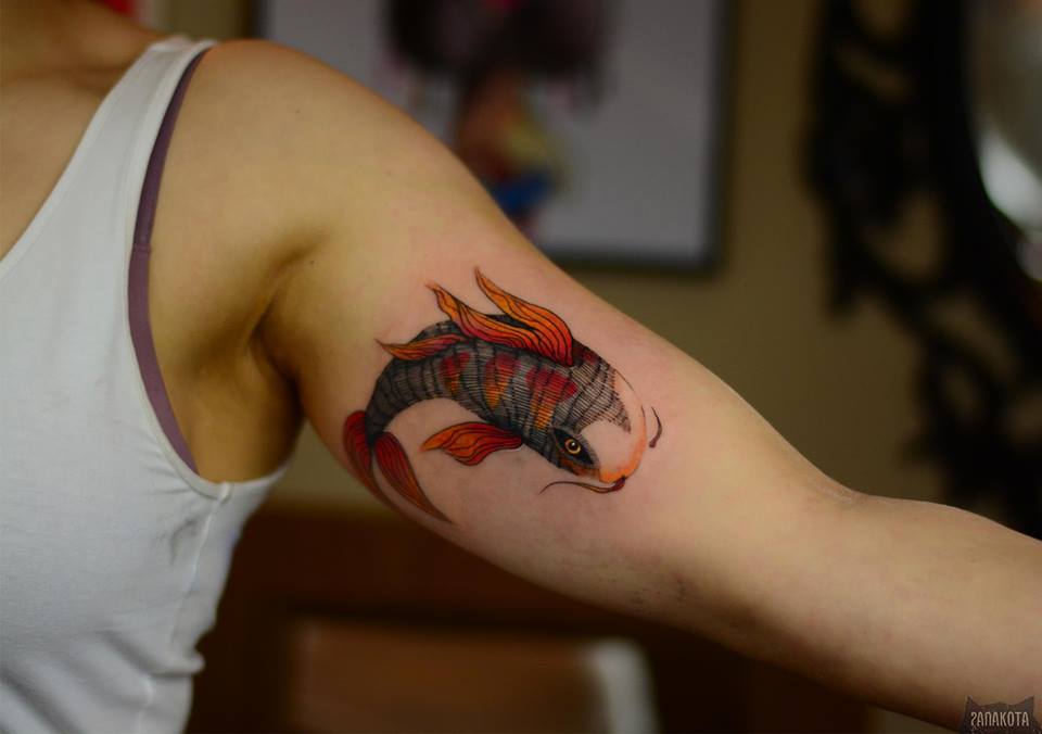 Wonderful Fish Tattoo On Man Left Bicep By Panakota