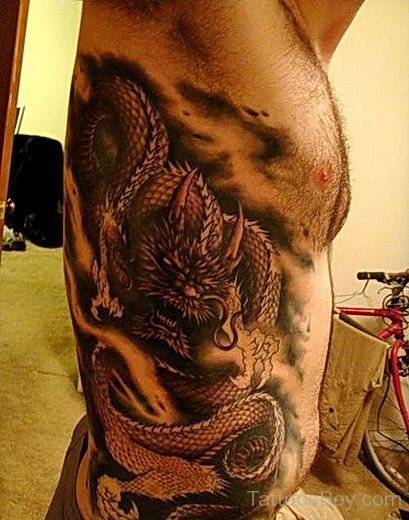 Amazing Black Ink Dragon Tattoo On Man Right Side Rib