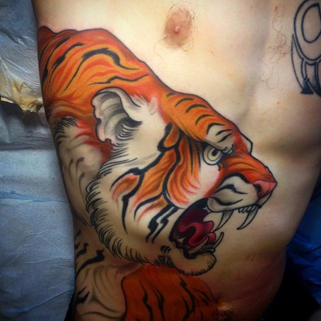 Amazing Tiger Tattoo On Man Right Side Rib By Jeff Norton