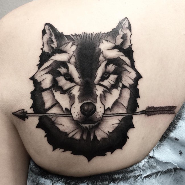 Arrow In Wolf Mouth Tattoo On Left Back Shoulder