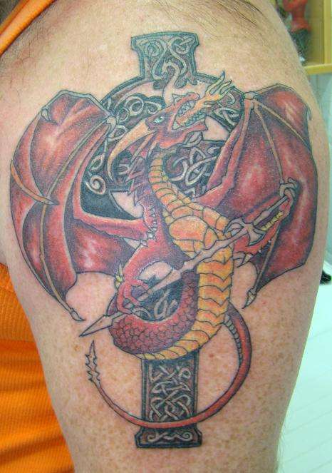 Attractive Dragon With Cross Tattoo On Shoulder