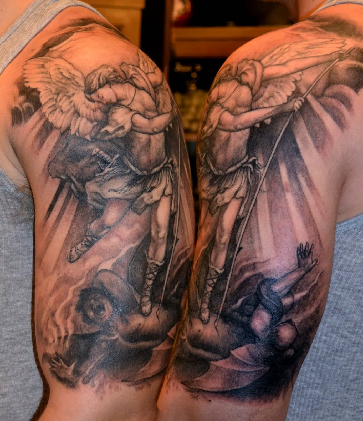 Awesome Black And Grey Archangel Michael Tattoo On Man Left Half Sleeve