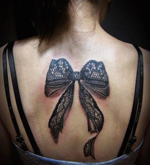 Awesome Black Ink 3D Bow Tattoo On Women Upper Back