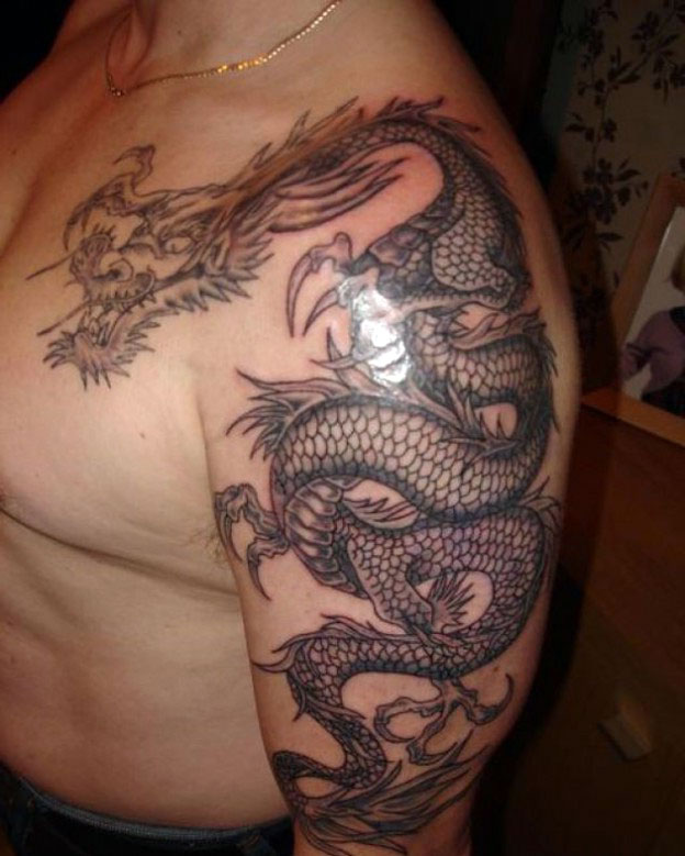 Awesome Black Ink Dragon Tattoo On Man Left Half Sleeve