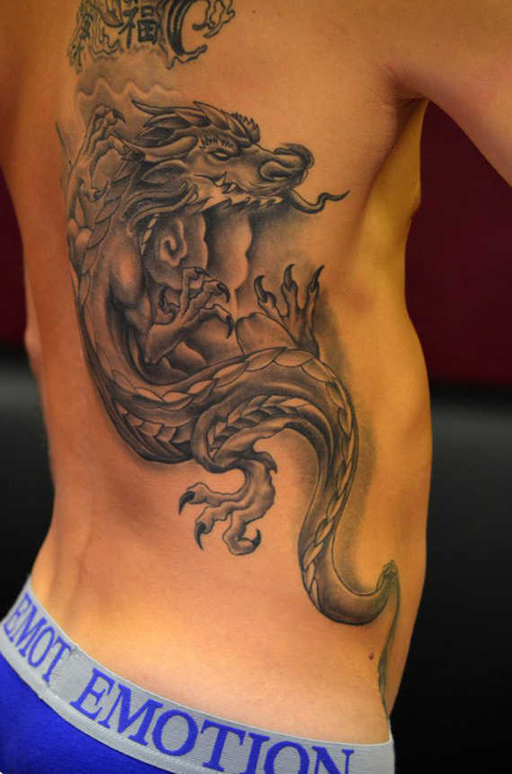 Awesome Black Ink Dragon Tattoo On Man Right Side Rib