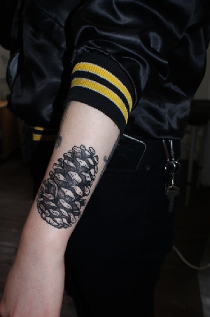 Awesome Black Ink Pine Cone Tattoo On Left Arm