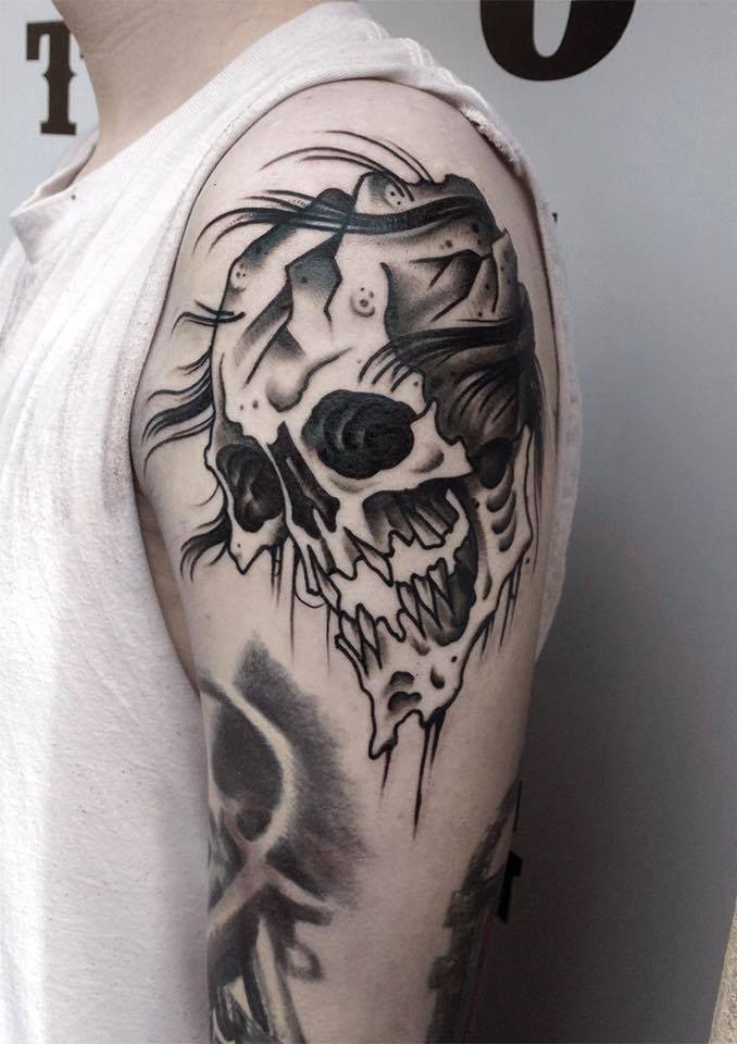 Awesome Black Ink Skull Tattoo On Man Left Shoulder