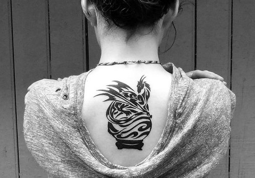 Awesome Black Tribal Dragon Tattoo On Girl Upper Back