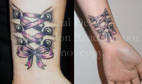 Awesome Corset Tattoo On Left Wrist By Gabriella Fraser