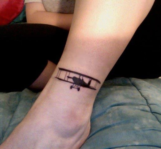 Awesome Silhouette Flying Airplane Tattoo On Left Leg