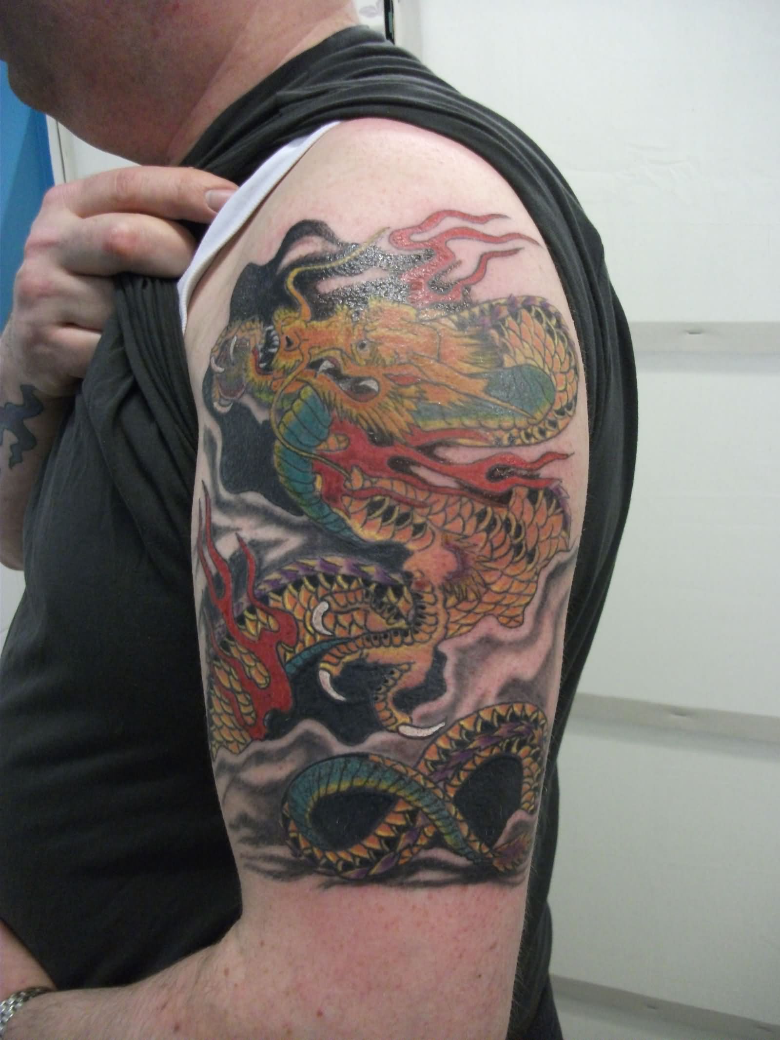 Awesome Traditional Dragon Tattoo On Man Left Half Sleeve
