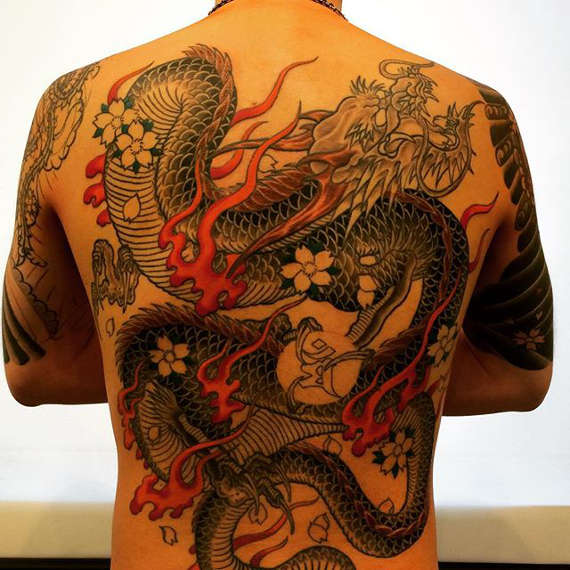 Awesome Traditional Dragon With Flowers Tattoo On Man Full Back