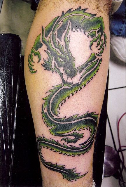 Black And Green Tribal Dragon Tattoo On Leg Calf