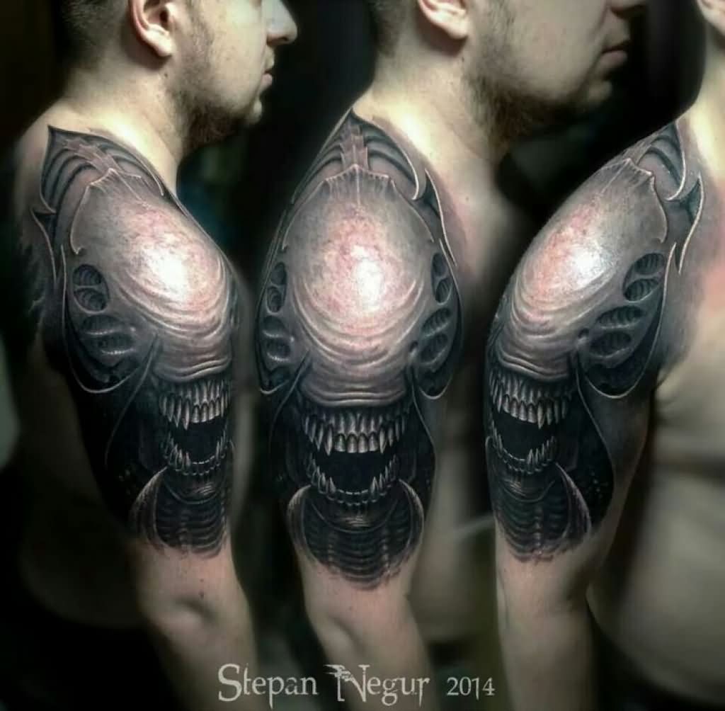 Black And Grey 3D Alien Head Tattoo On Man Right Shoulder By Stepan Negur