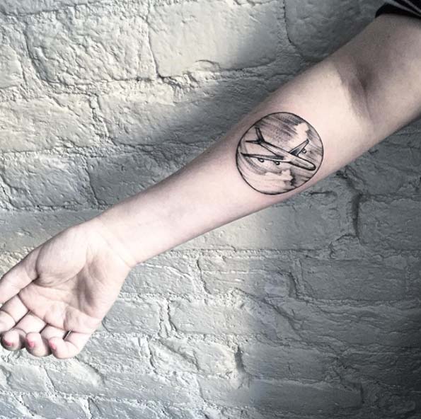 Black And Grey Airplane In Circle Tattoo On Right Forearm