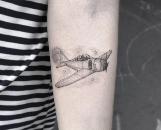 Black And Grey Airplane Tattoo On Forearm