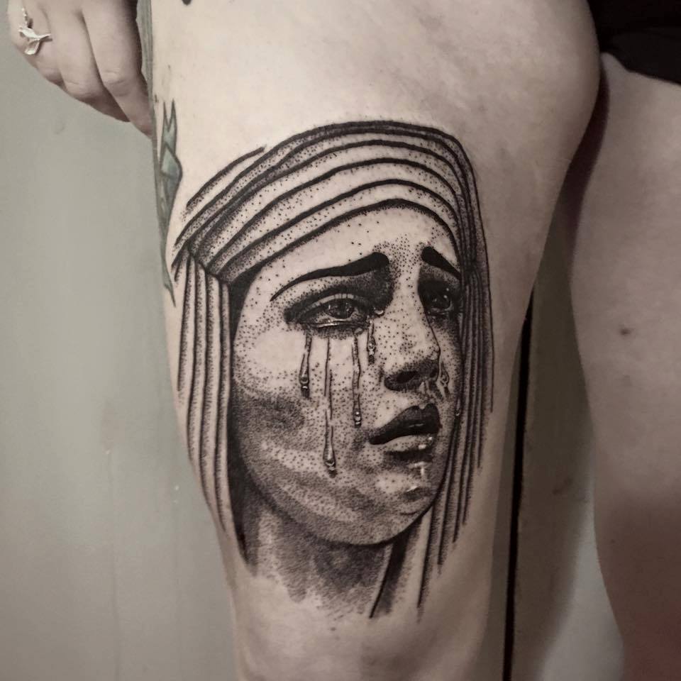 Black And Grey Crying Women Head Tattoo On Thigh