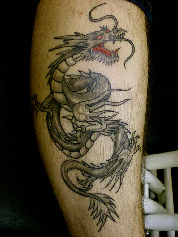 Black And Grey Dragon Tattoo On Leg