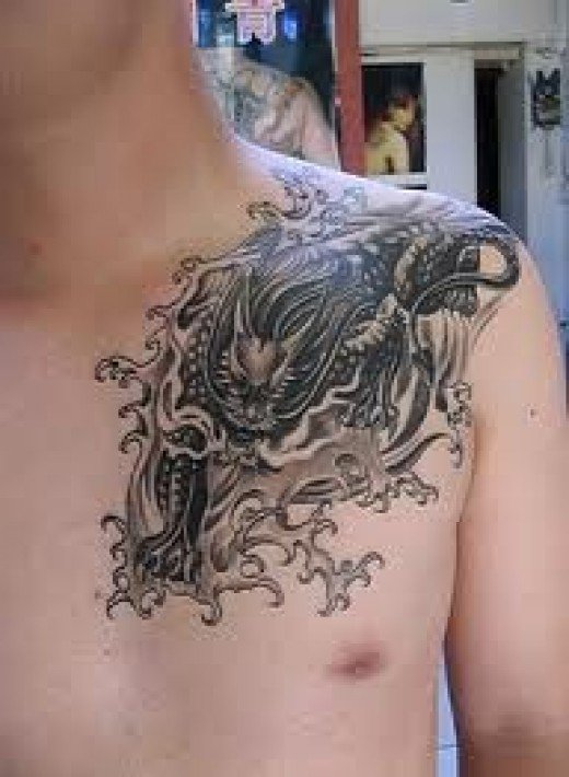 Black And Grey Dragon Tattoo On Man Left Front Shoulder
