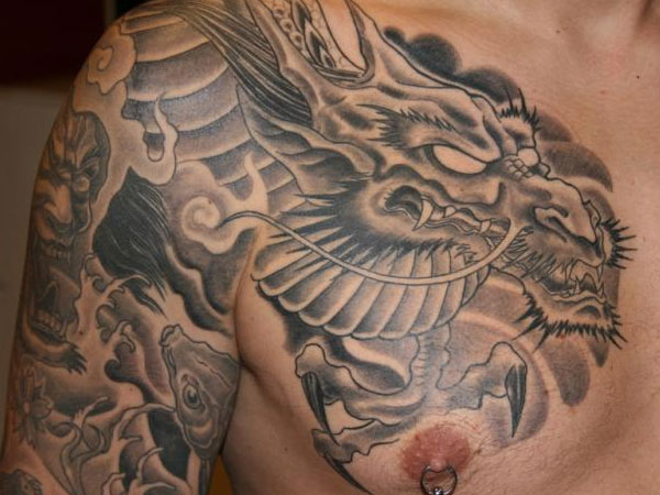 Black And Grey Dragon Tattoo On Man Right Shoulder And Chest