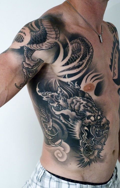 Black And Grey Dragon Tattoo On Man Right Side Rib