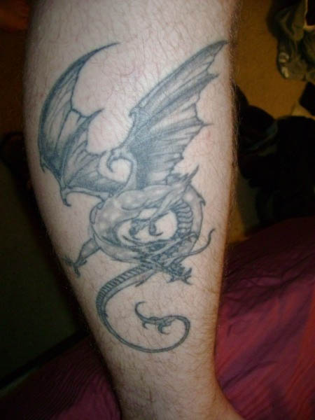 Black And Grey Dragon Tattoo On Upper Leg