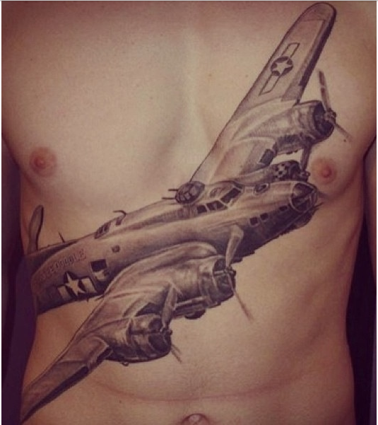 Black And Grey Flying Airplane Tattoo On Man Chest
