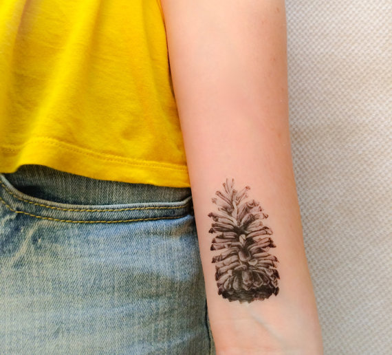 Black And Grey Pine Cone Tattoo On Left Wrist