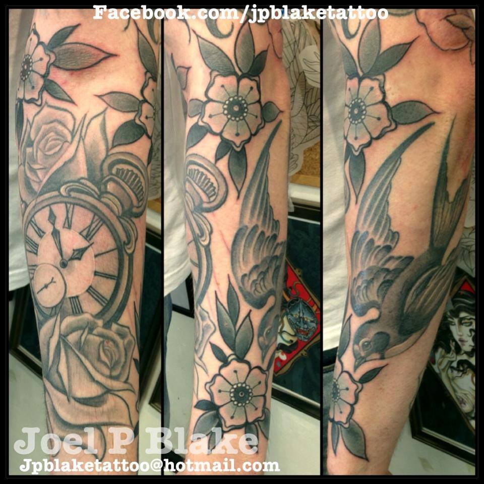 Black And Grey Pocket Watch With Flowers And Flying Bird Tattoo On Arm