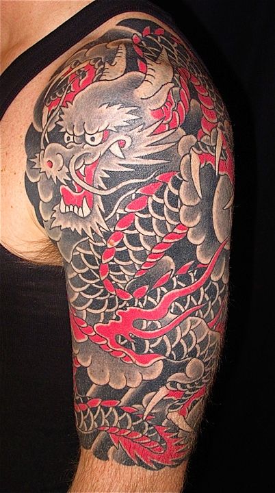 Black And Pink Dragon Tattoo On Man Left Half Sleeve