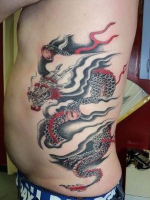 Black And Red Dragon Tattoo On Man Left Side Rib