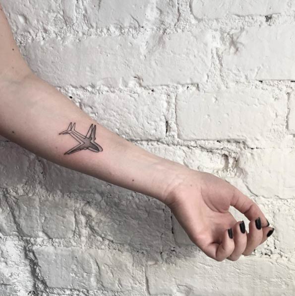 Black Ink Airplane Tattoo On Left Forearm