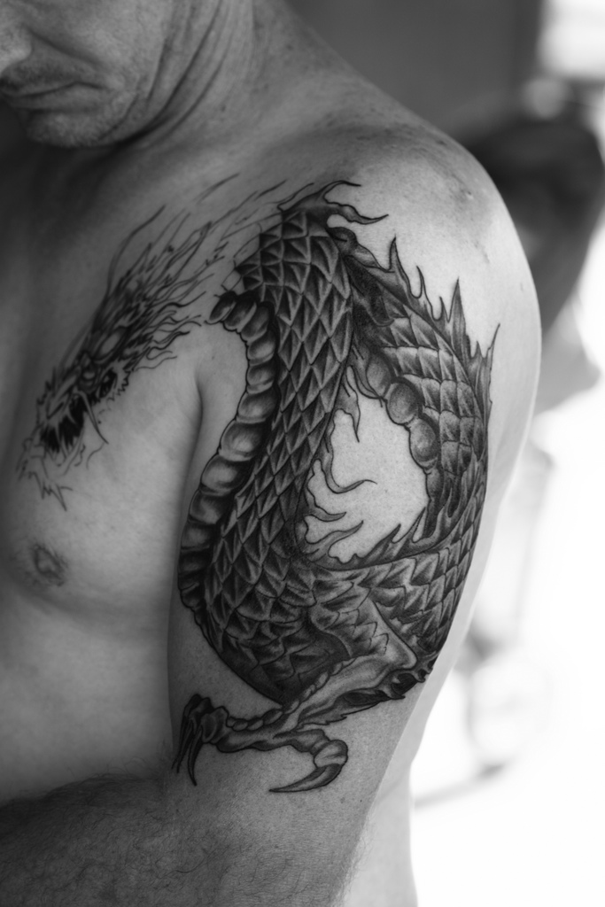 Black Ink Chinese Dragon Tattoo On Man Left Half Sleeve