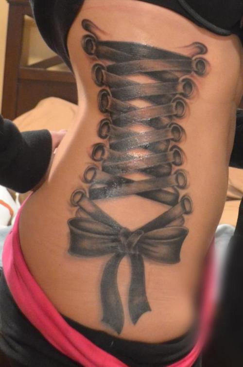 Black Ink Corset With Bow Tattoo On Women Right Side Rib