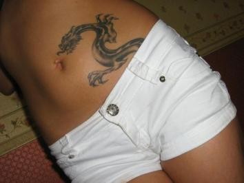 Black Ink Dragon Tattoo On Girl Stomach