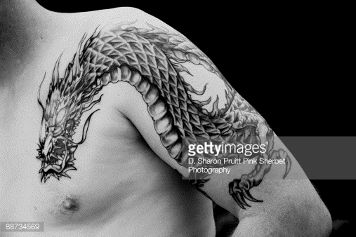 Black Ink Dragon Tattoo On Man Left Half Sleeve And Front Shoulder