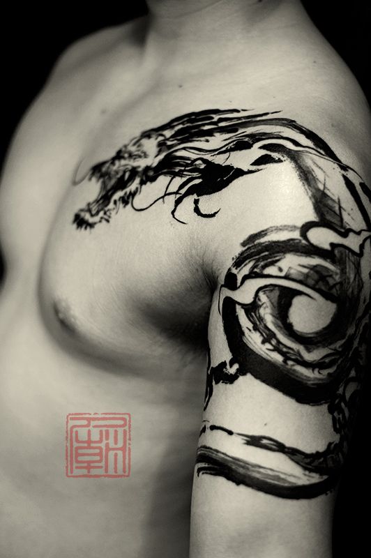 Black Ink Dragon Tattoo On Man Left Shoulder