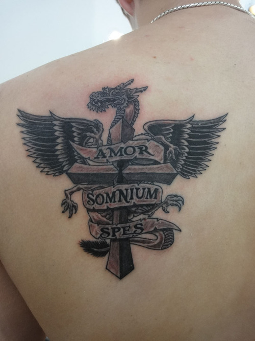 Black Ink Dragon With Cross And Banner Tattoo On Left Back Shoulder