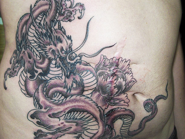 Black Ink Dragon With Flower Tattoo On Stomach