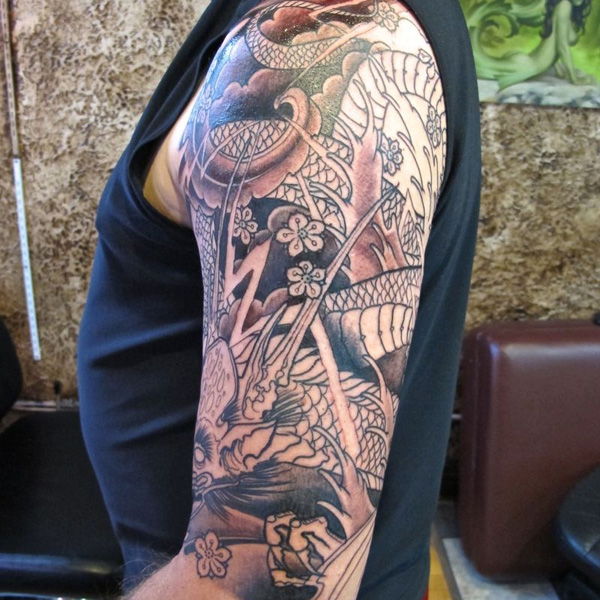Black Ink Dragon With Flowers Tattoo On Left Half Sleeve