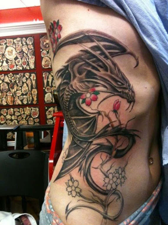 Black Ink Dragon With Flowers Tattoo On Right Side Rib