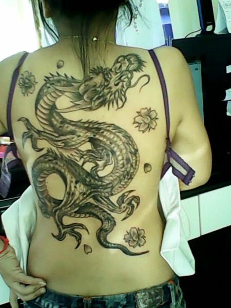 Black Ink Dragon With Flowers Tattoo On Women Full Back