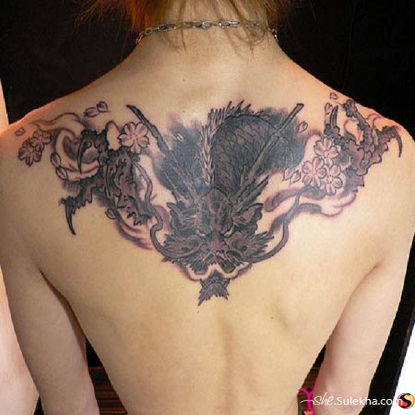 Black Ink Dragon With Flowers Tattoo On Women Upper Back