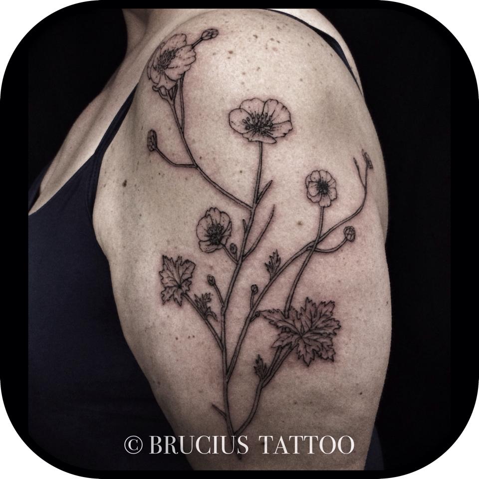 Black Ink Flower Tattoo On Left Shoulder